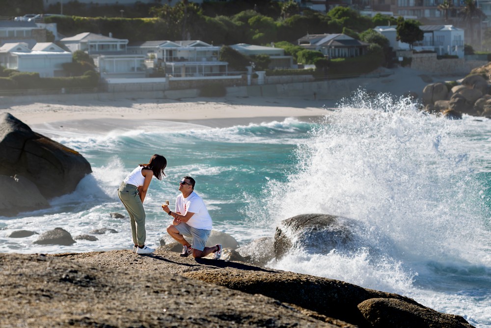 Cape Town Proposal Photography Huge wave crashing as he pops the question